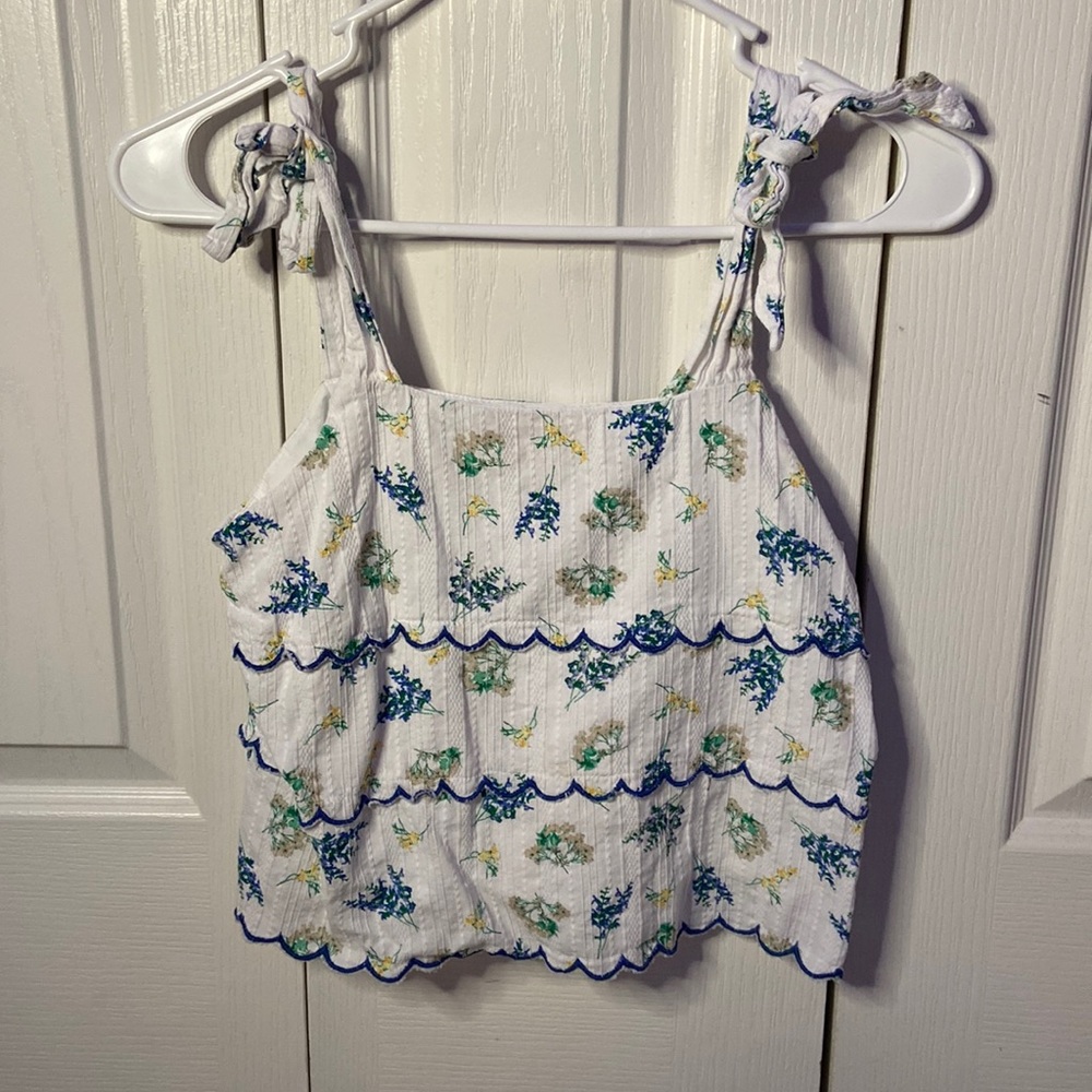 Blue and white tank top with floral print.